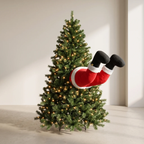 A Christmas tree with warm white lights, featuring a Santa Claus leg and foot decoration hanging horizontally against a neutral indoor wall.