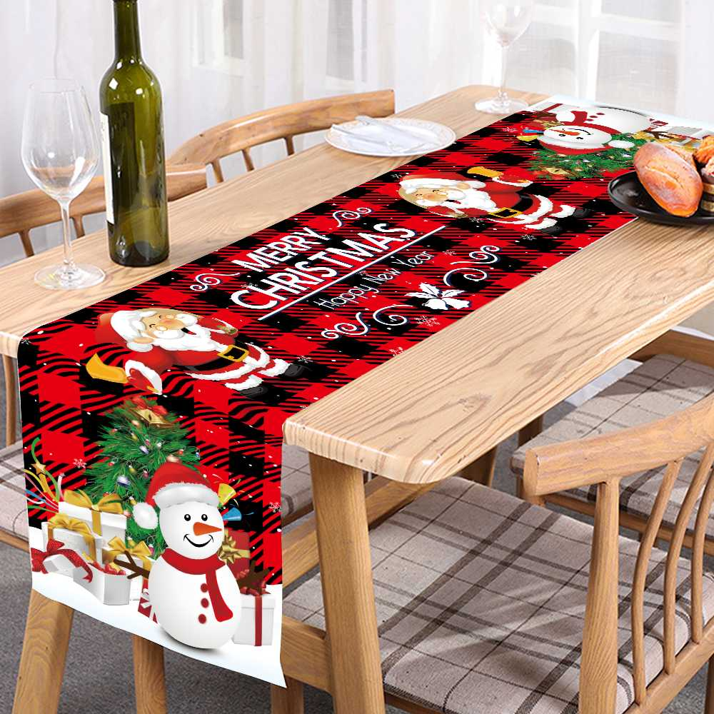 Christmas-themed table runner with Santa Claus and snowman on a dining table.
