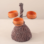 A decorative three-bowl pet feeder shaped like a tree trunk, with three orange bowls mounted on a faux wood branch structure, shown on a plain beige studio background.