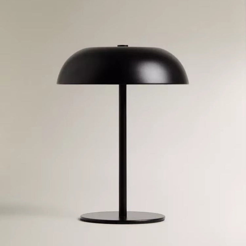 Black table lamp on a light beige background