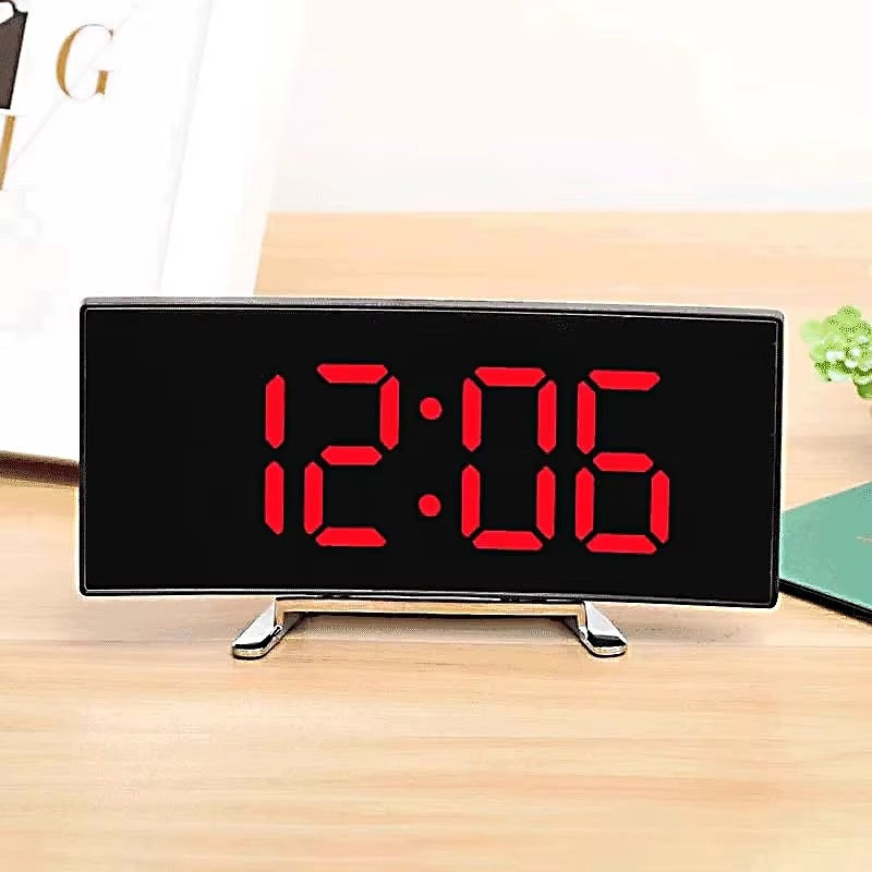 Digital clock with red LED display on a wooden surface