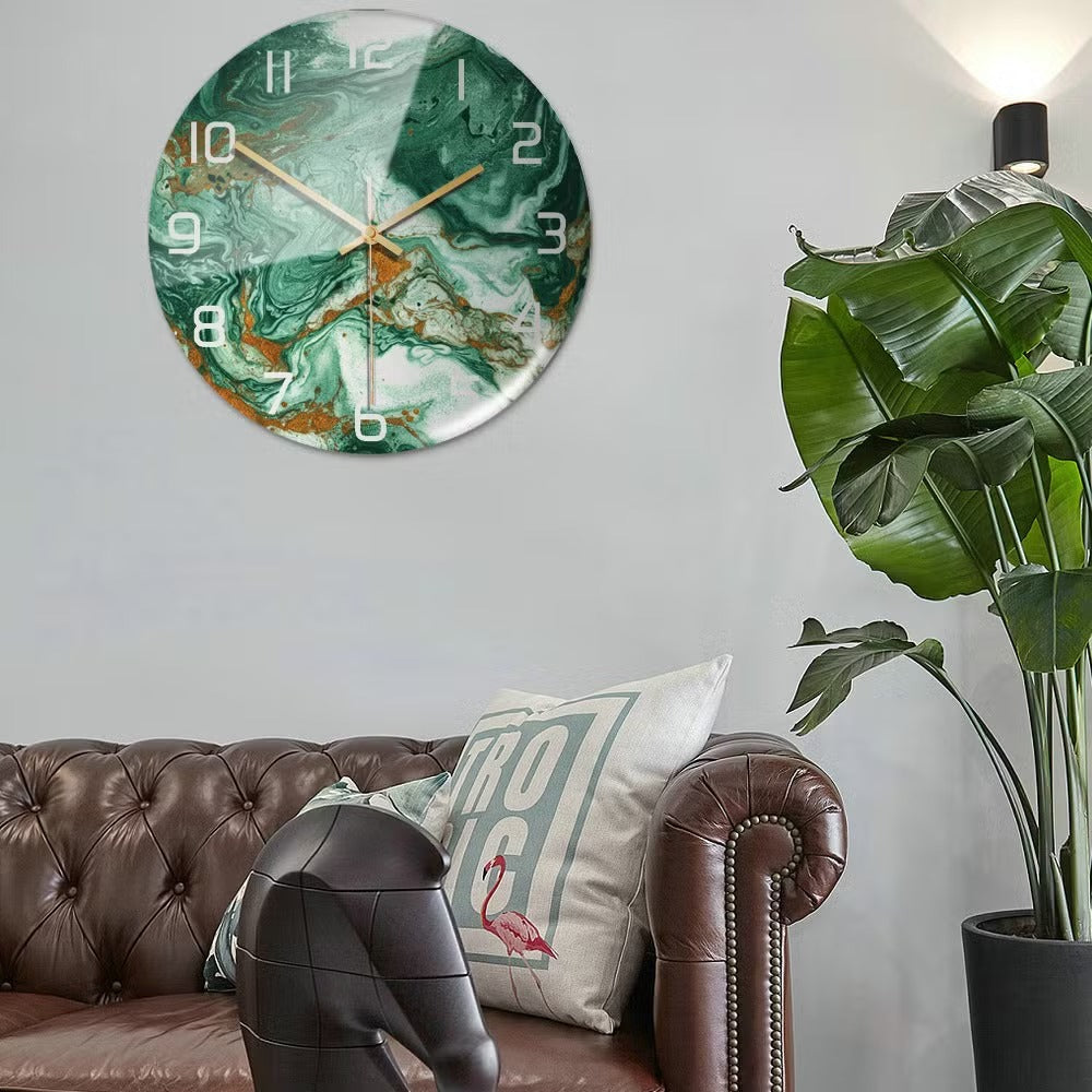 Marble-patterned clock on a wall above a brown sofa with decorative pillows and a plant.