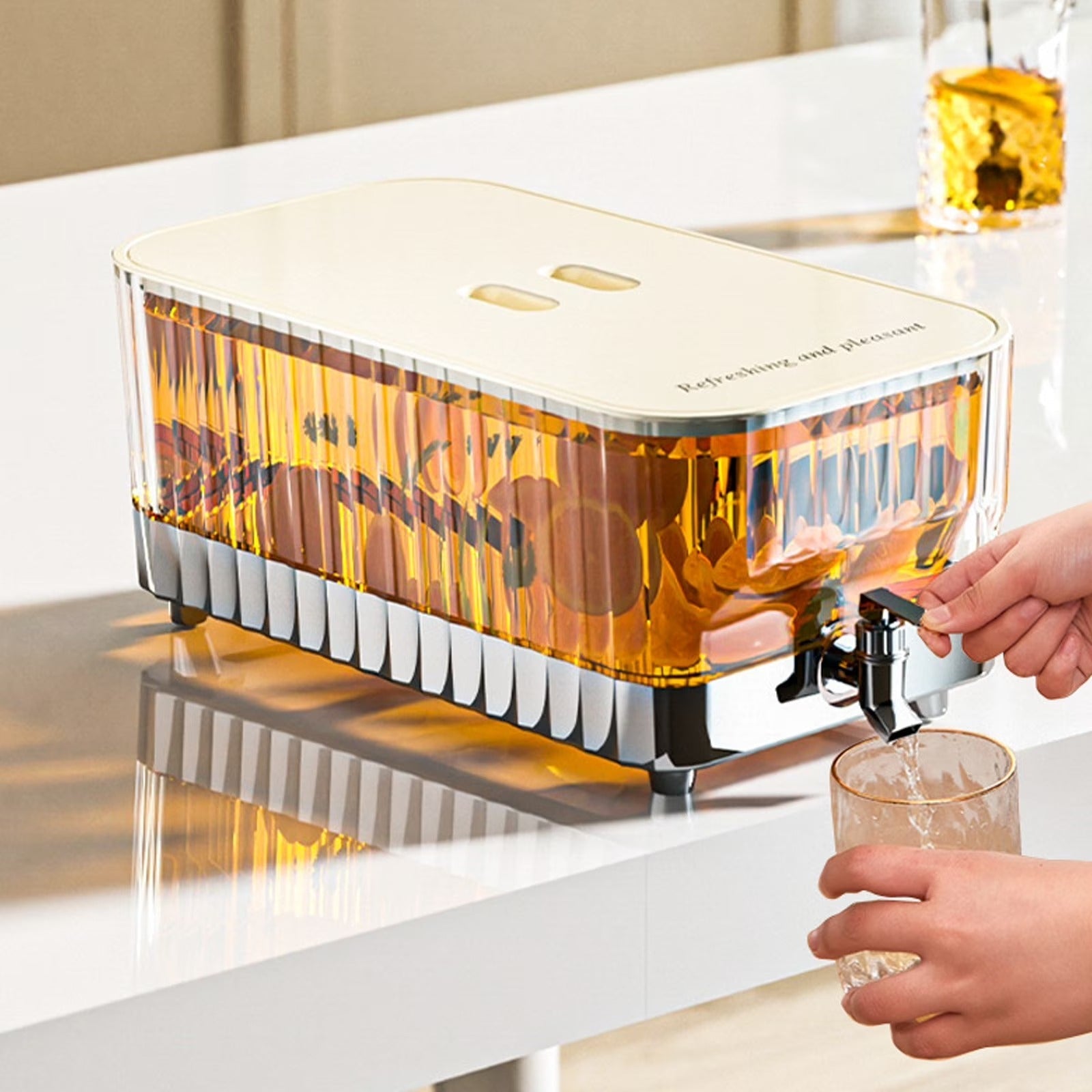 Beverage dispenser pouring a drink into a glass on a white surface.