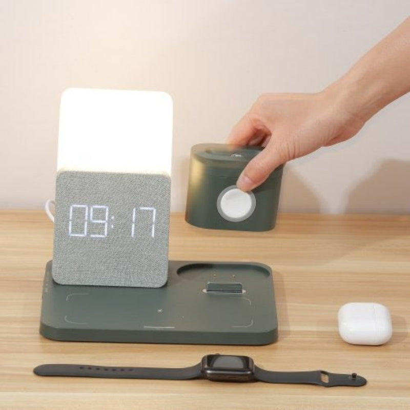 Smart home device with digital display on a wooden surface, hand interacting with it.