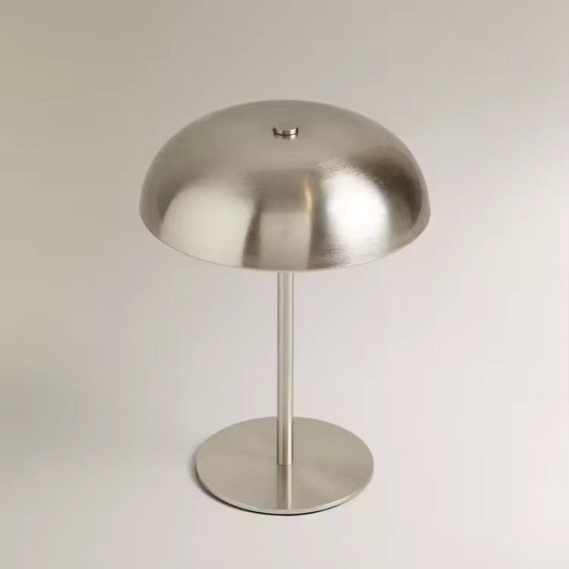 Metallic table lamp on a plain background