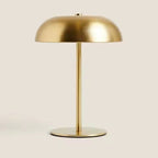 Gold table lamp on a beige background