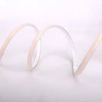 Close-up of a coiled white cable on a light gray background
