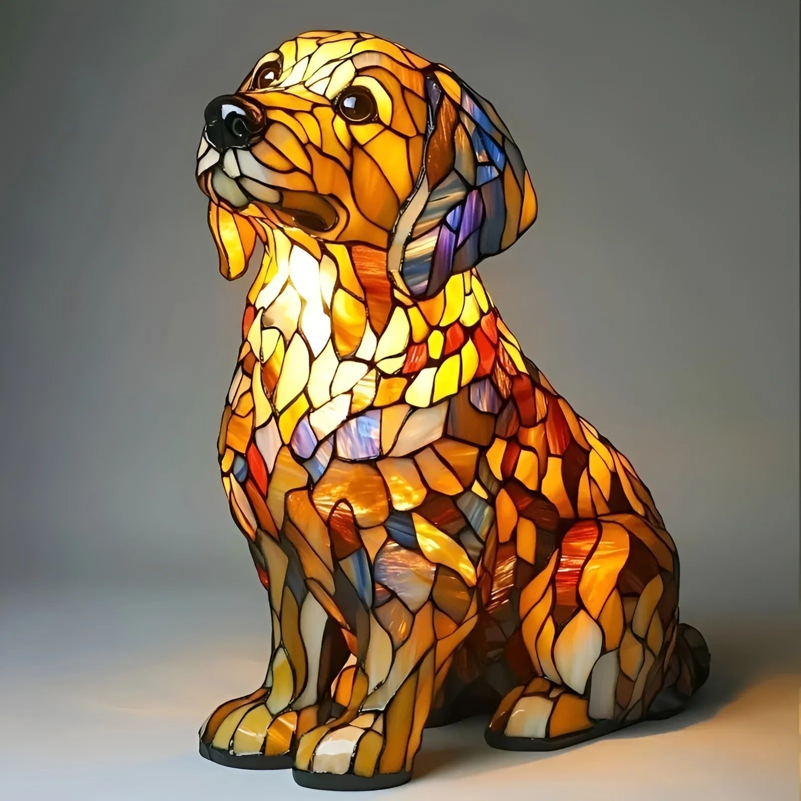 Stained glass dog-shaped lamp on a gray background