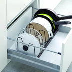 Pots and pans in a pull-out kitchen drawer organizer.