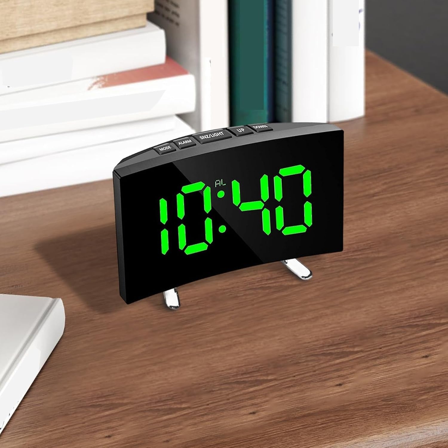 Digital clock with green LED display on a wooden surface