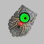 Toy car tire with spider design and glowing eyes on a gray background