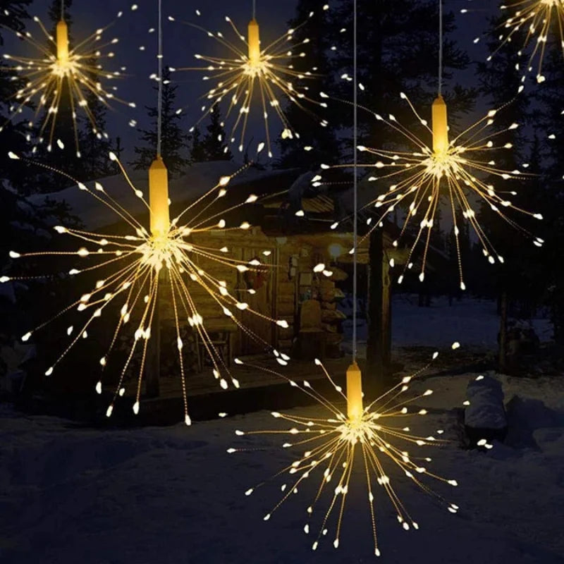 Decorative string lights resembling fireworks in a snowy outdoor setting.