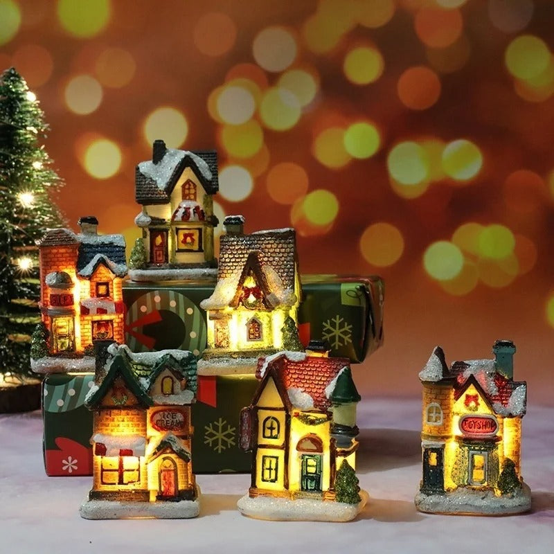 Set of illuminated miniature Christmas houses with a festive background