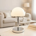 Modern table lamp on a table with a blurred living room background