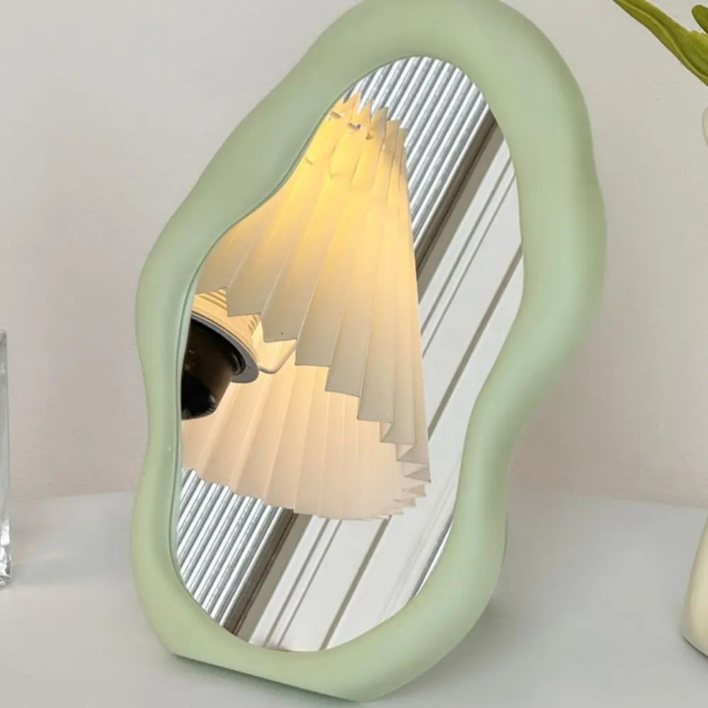 Decorative lamp with a unique green frame on a white surface.