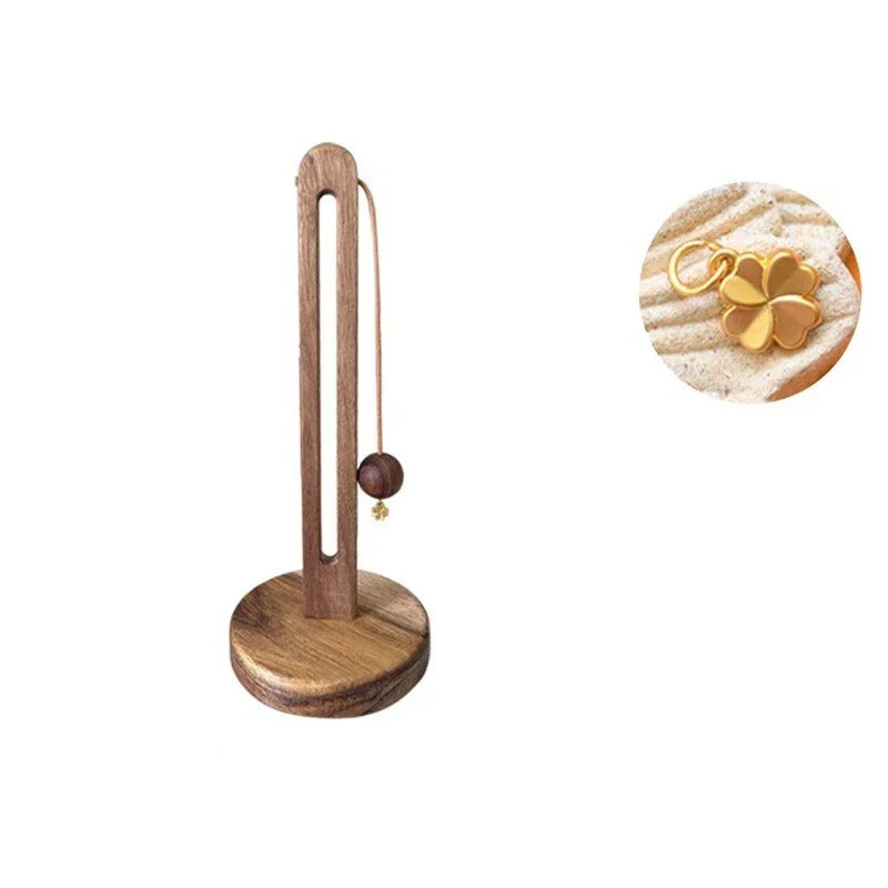 Wooden stand with a gold pendant and measurements on a white background