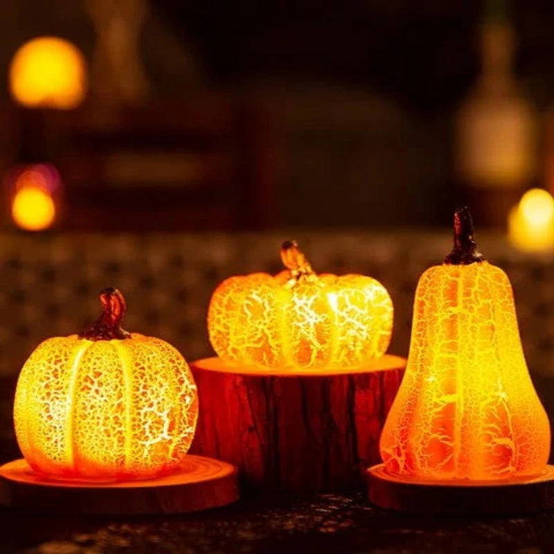 Three decorative pumpkins with a textured surface, glowing warmly against a blurred background.